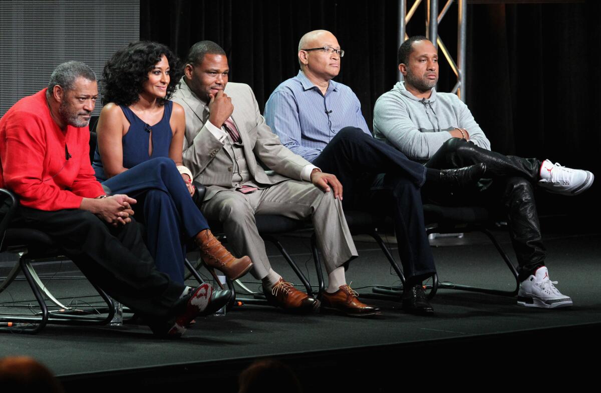 From left, actors Laurence Fishburne, Tracee Ellis Ross, Anthony Anderson, executive producer Larry Wilmore and creator/executive producer Kenya Barris speak onstage at the "Black-ish" panel.