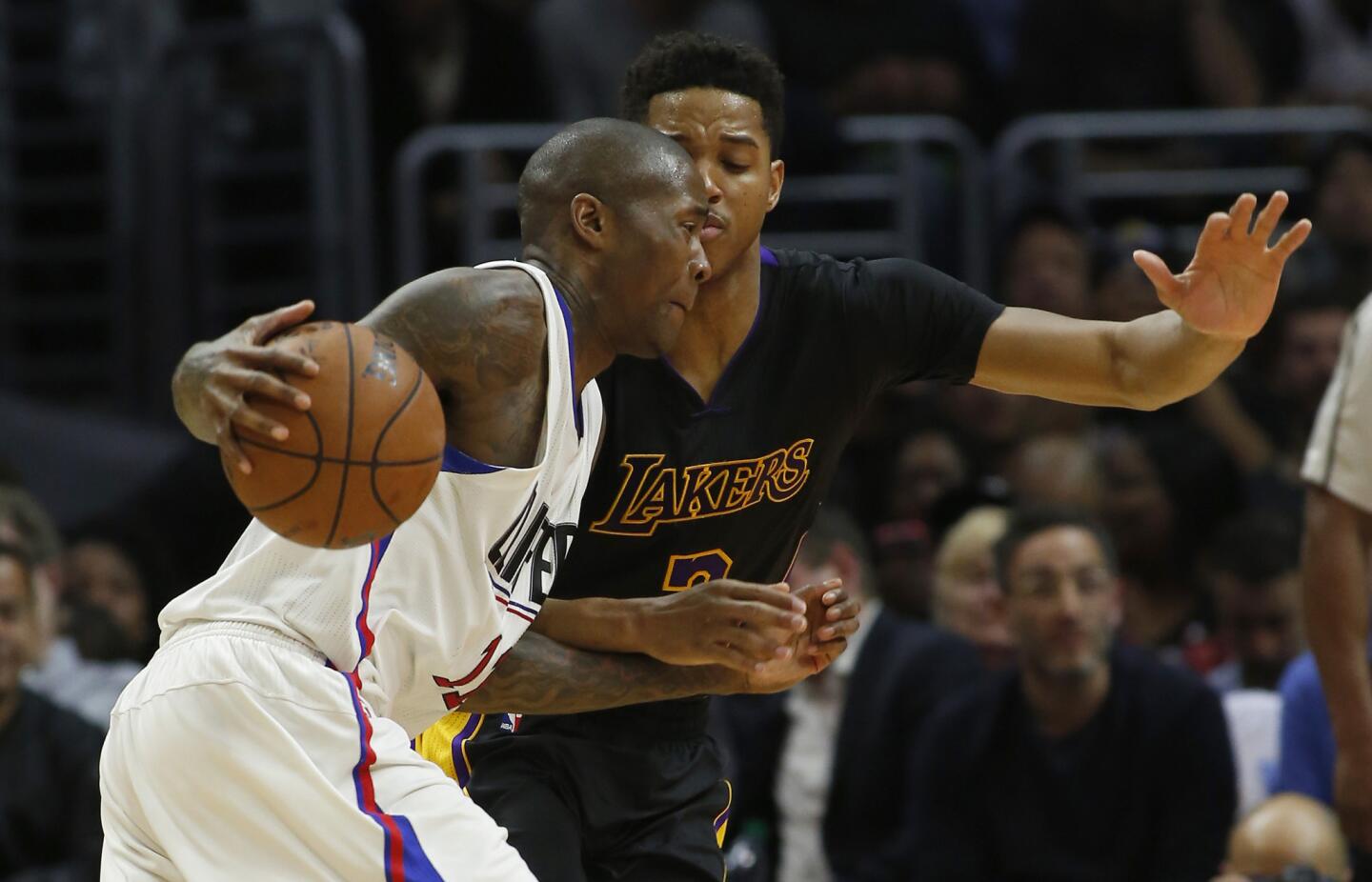 Clippers' Jamal Crawford, left, drives on Lakers' Anthony Brown, right, in fourth quarter on Friday.