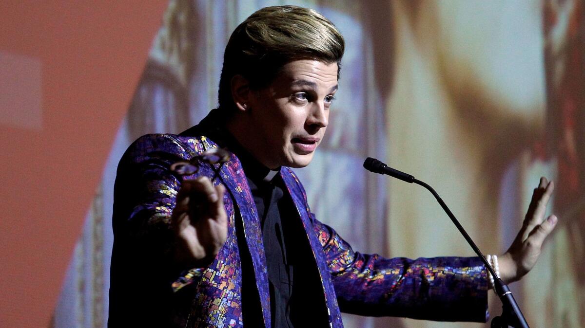 Conservative provocateur Milo Yiannopoulos speaks to a crowd at Cal State Fullerton on Oct. 31.