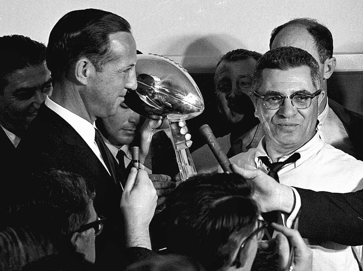 NFL commissioner Pete Rozelle, left, presents the championship trophy to Green Bay coach Vince Lombardi.