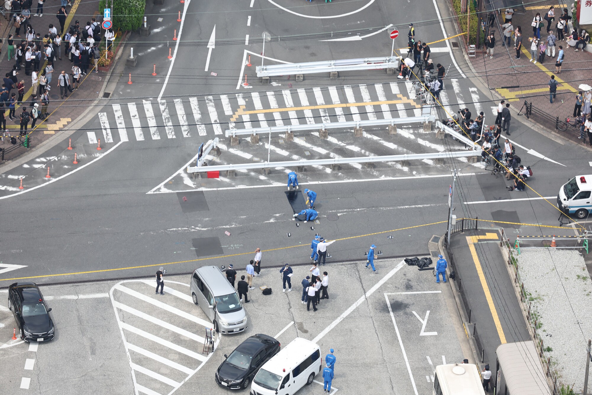 An aerial view taken shows police working at the scene at Kintetsu Yamato-Saidaiji Station in Nara 