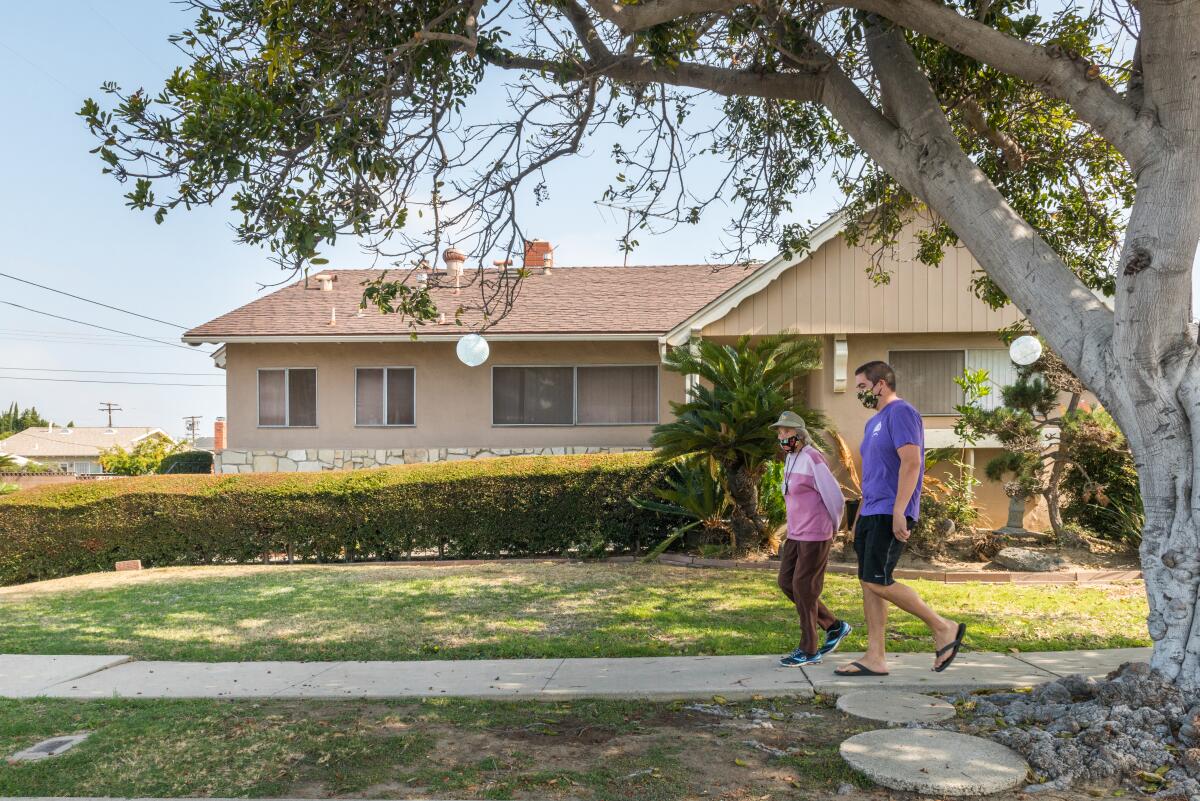 Daisy Conant takes a walk with her grandson, her primary caregiver.