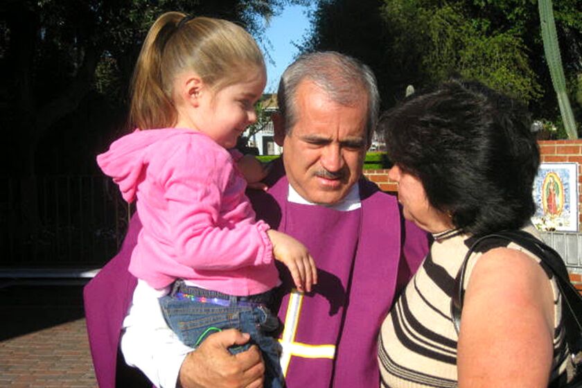 Father Francisco Valdovinos, shown here with parishioners, died last January of COVID-19 at 58.