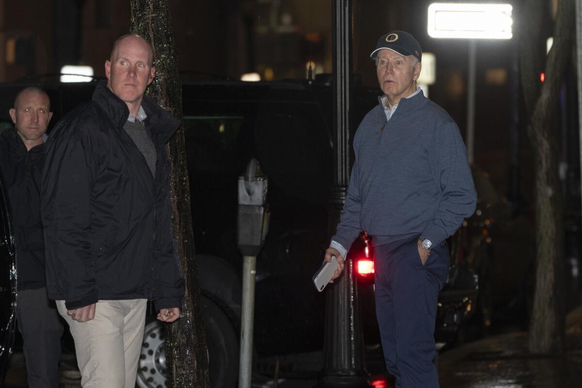 Three men, including President Biden, outside a building