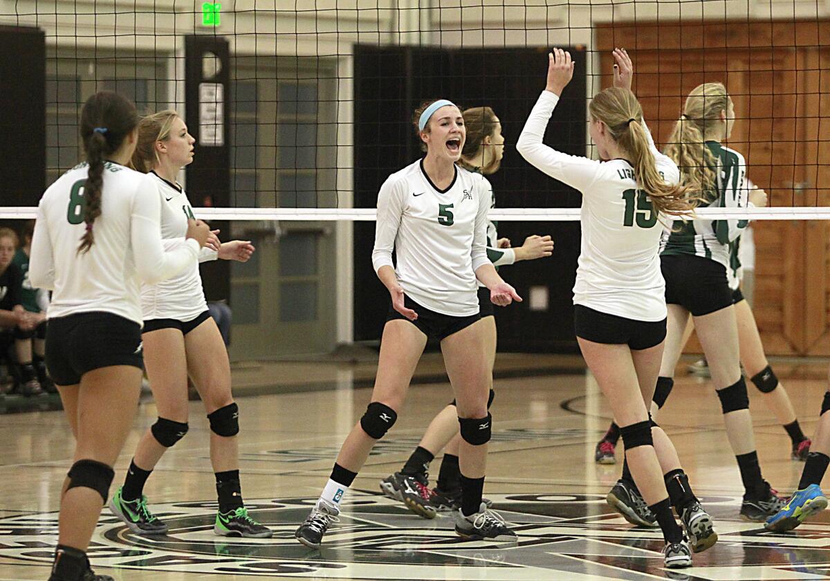 Sage Hill's Juliette Singarella, 5, and Maddy Abbott, 15, celebrate a point against Templeton during the CIF Southern Section quarterfinal division 3A volleyball playoffs at Sage Hill on Saturday.