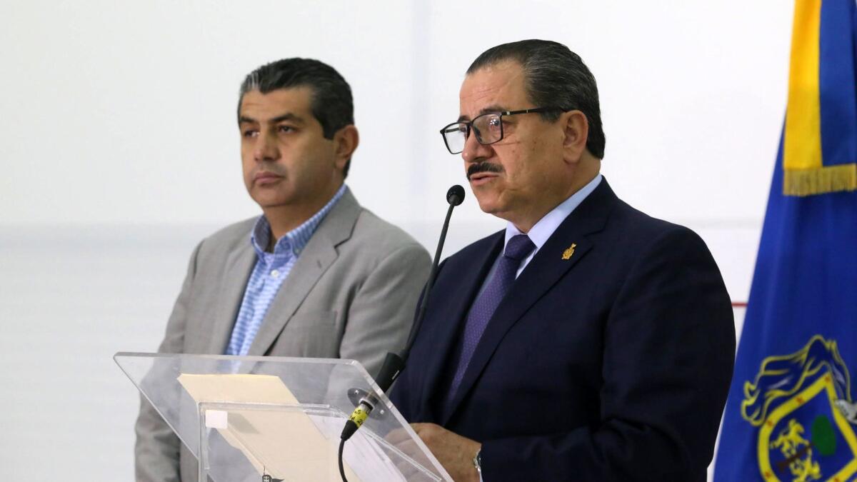 Jalisco Atty. Gen. Raul Sanchez Jimenez, right, speaks at a news conference with regional prosecutor Fausto Mancilla in Guadalajara on Tuesday.