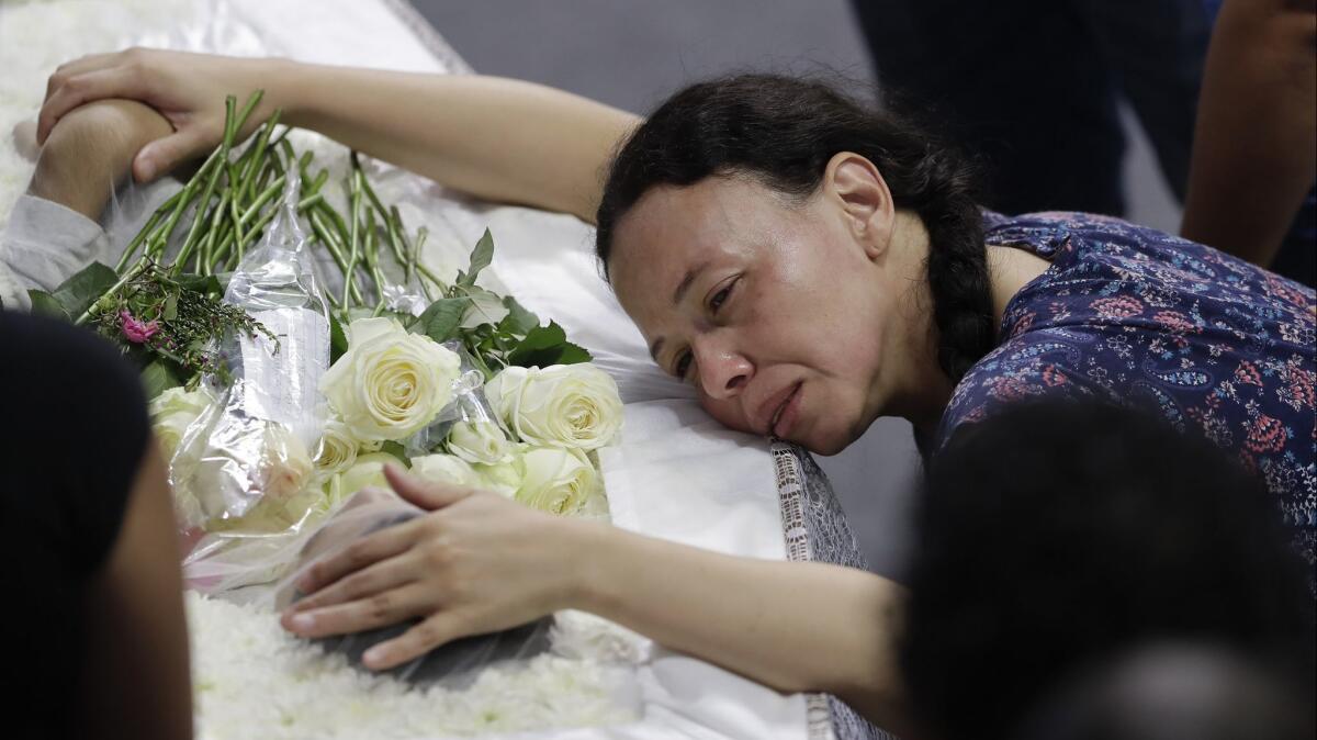 A relative mourns 15-year-old Caio Oliveira, a victim of a mass shooting at the Raul Brasil public school in Suzano, Brazil, on March 14.