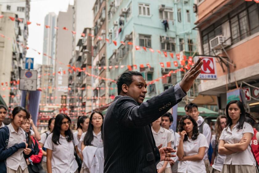 Jeffrey Andrews leads a group of high school students tour to show them the lives of minority and refugee on March 20, 2019, in Hong Kong, China. Andrews, 33, of Indian origin, is born and raised in Hong Kong who speaks fluent Cantonese and English but limited Tamil. He is the first registered ethnic minority social worker in the city.