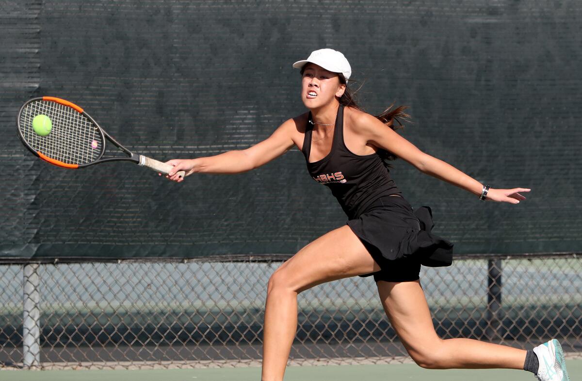 Huntington Beach singles player Yen Nhi Hunyh returns a shot on Wednesday at Whittier Narrows Tennis Center.