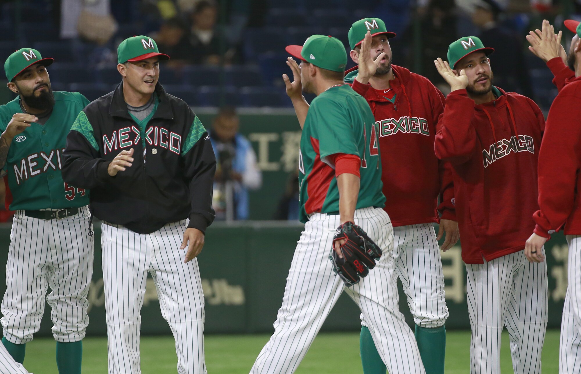 Mexico’s manager Edgar González, second from left, celebrates with his team after a win over Japan in 2016