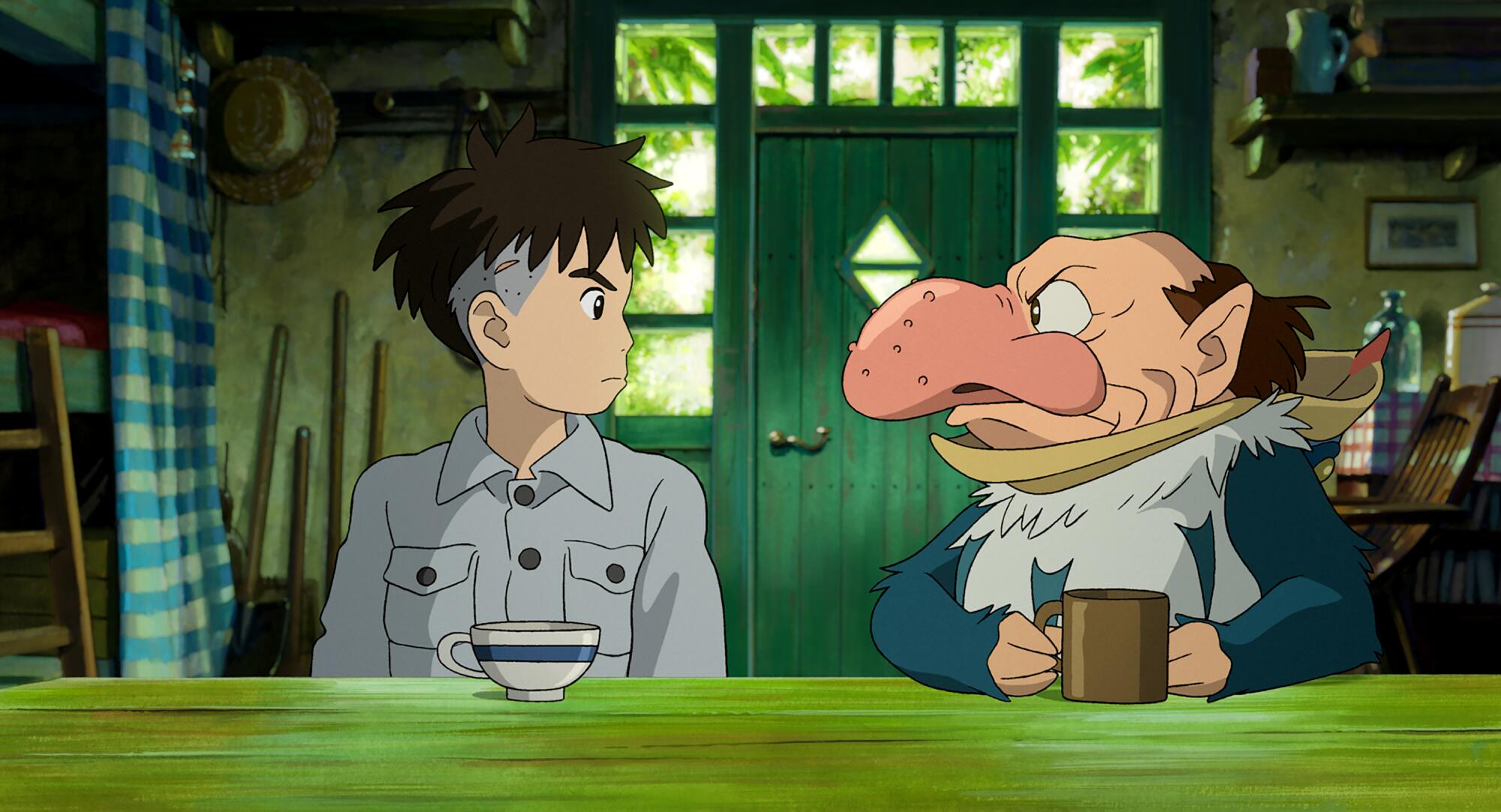 A young man has tea with a big-nosed creature in a heron costume.