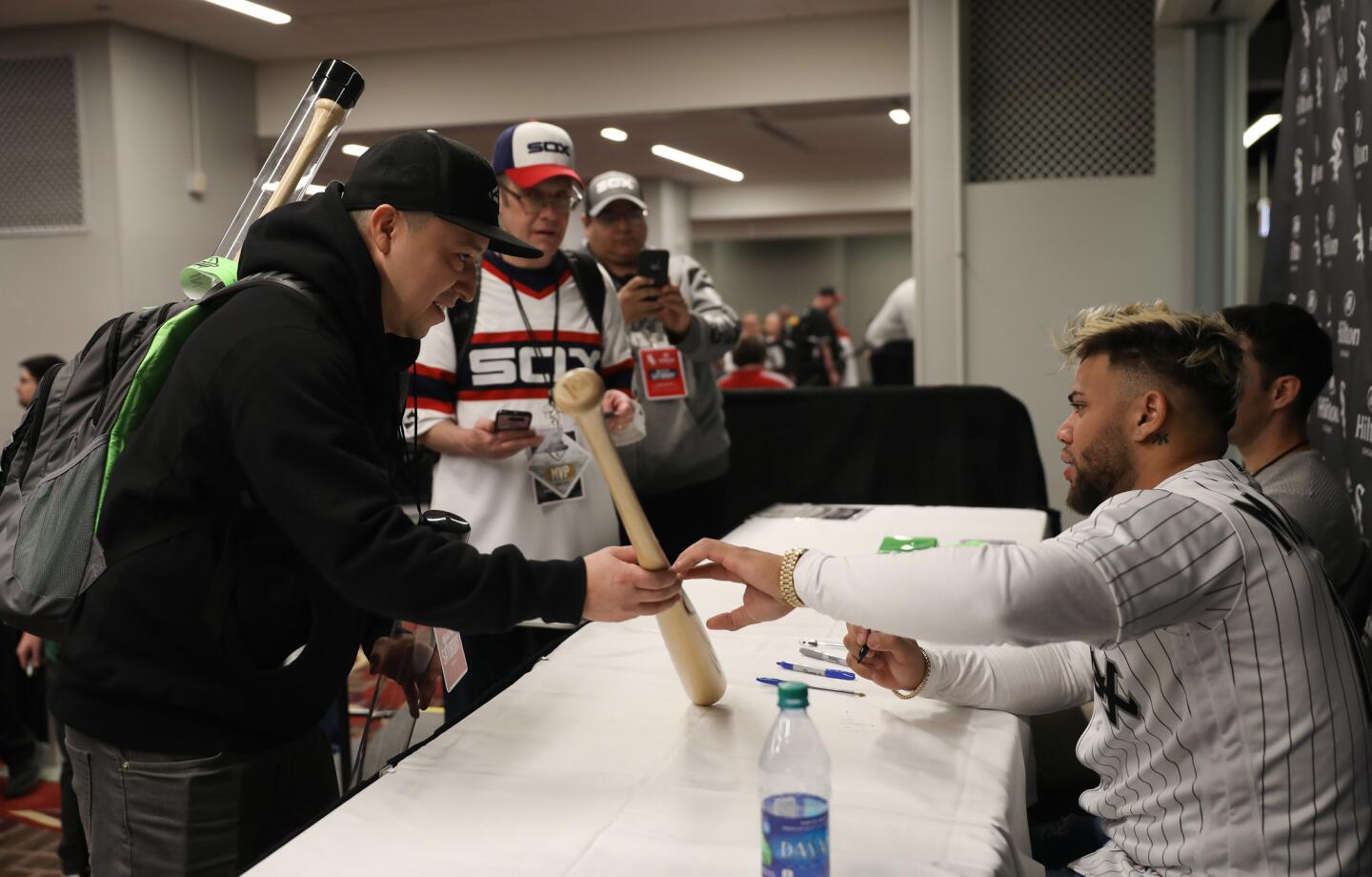 Fan Fernando Mendez gets his bat autographed by the White Sox's Yoan Moncada during SoxFest on Jan. 26, 2019, at the Hilton Chicago.