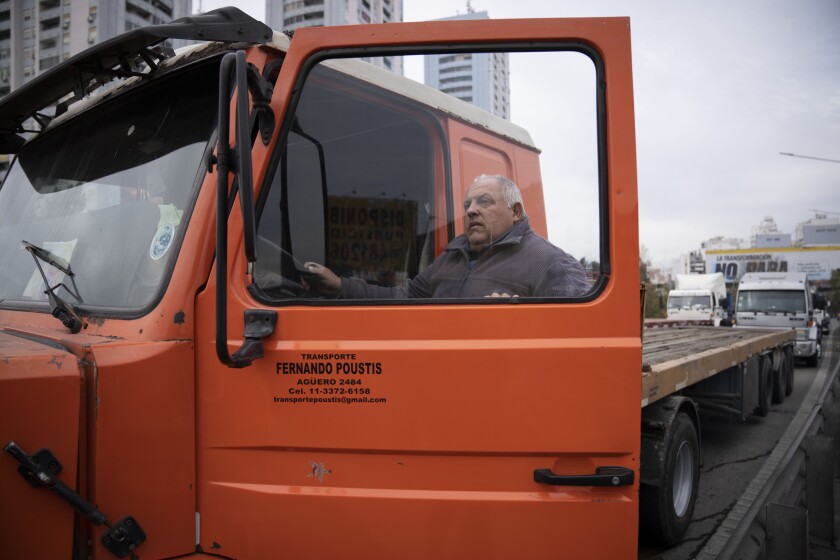 A trucker partially blocks the southern entrance to Buenos Aires, Argentina, Tuesday, June 28, 2022. Dozens of truckers tried to enter the center of the city Tuesday to protest the lack of diesel but were stopped by the police and forced to return. (AP Photo/Victor R. Caivano)