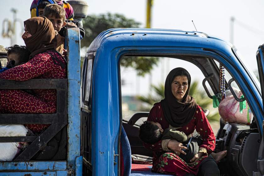 Syrian families fleeing the battle zone between Turkey-led forces and Kurdish fighters from the Syrian Democratic Forces (SDF) in and around the northern flashpoint town of Ras al-Ain on the border with Turkey, arrive along with Syrian Arab and Kurdish civilians in the city of Tal Tamr on the outskirts of Hasakeh on October 15, 2019. - Kurdish forces held on to a key border town Tuesday, seven days into a deadly Turkish invasion in northeastern Syria that caused mass displacement and reshaped the region. (Photo by Delil SOULEIMAN / AFP) (Photo by DELIL SOULEIMAN/AFP via Getty Images) ** OUTS - ELSENT, FPG, CM - OUTS * NM, PH, VA if sourced by CT, LA or MoD **