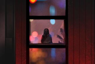 silhouette of a seated woman seen through a window with red and blue lights reflected in the glass