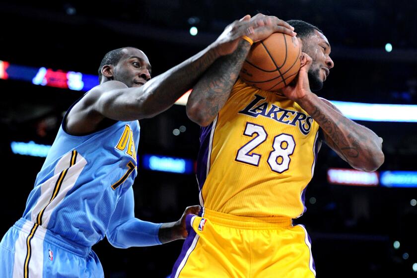 Lakers forward Tarik Black grabs a rebound from Nuggets forward J.J. Hickson during a game at Staples Center on Nov. 3.