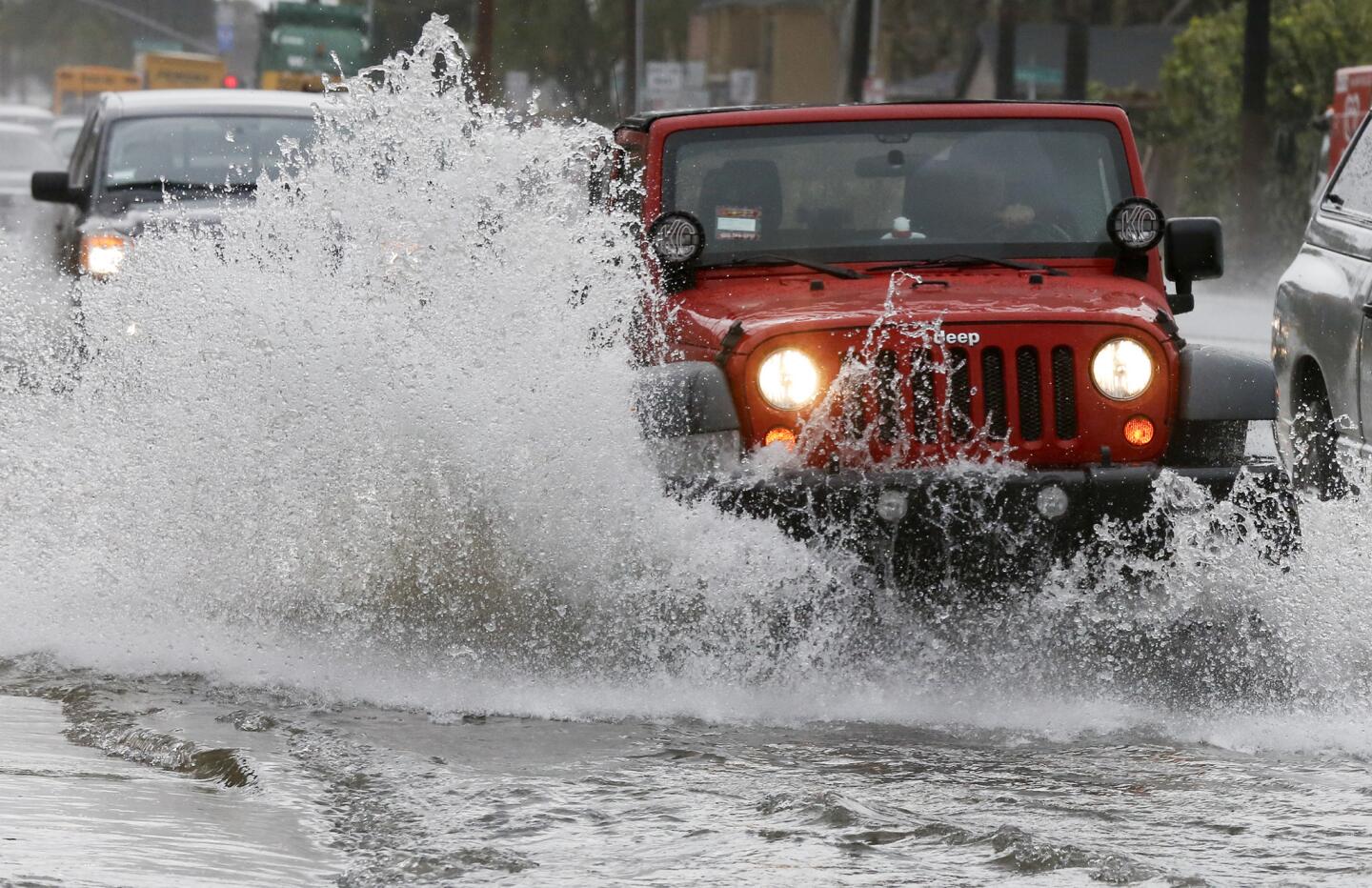 Motorists navigate the flooded lanes of northbound Fairview Street in Santa Ana.