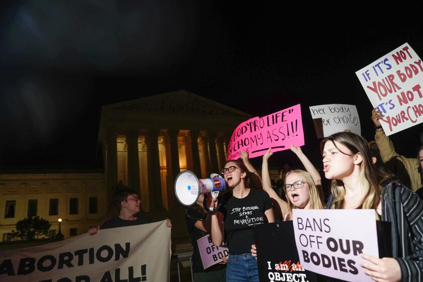 A crowd gathers outside the Supreme Court on Monday night