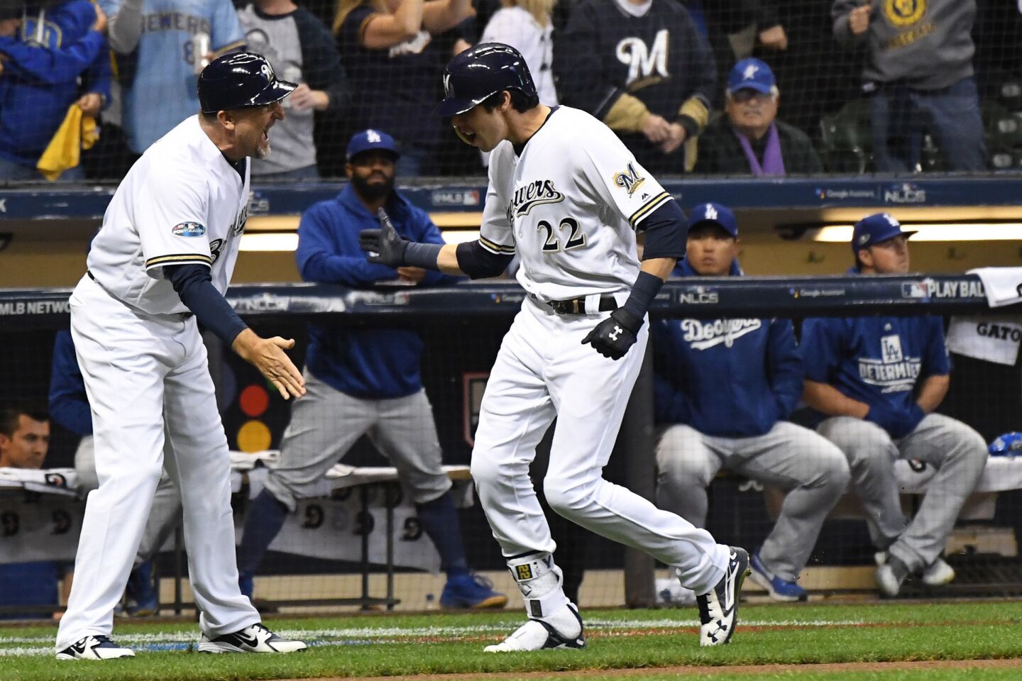 With the Dodgers looking on, Milwaukee Brewers Christian Yelich celebrates after hitting a solo homerun in the first inning.