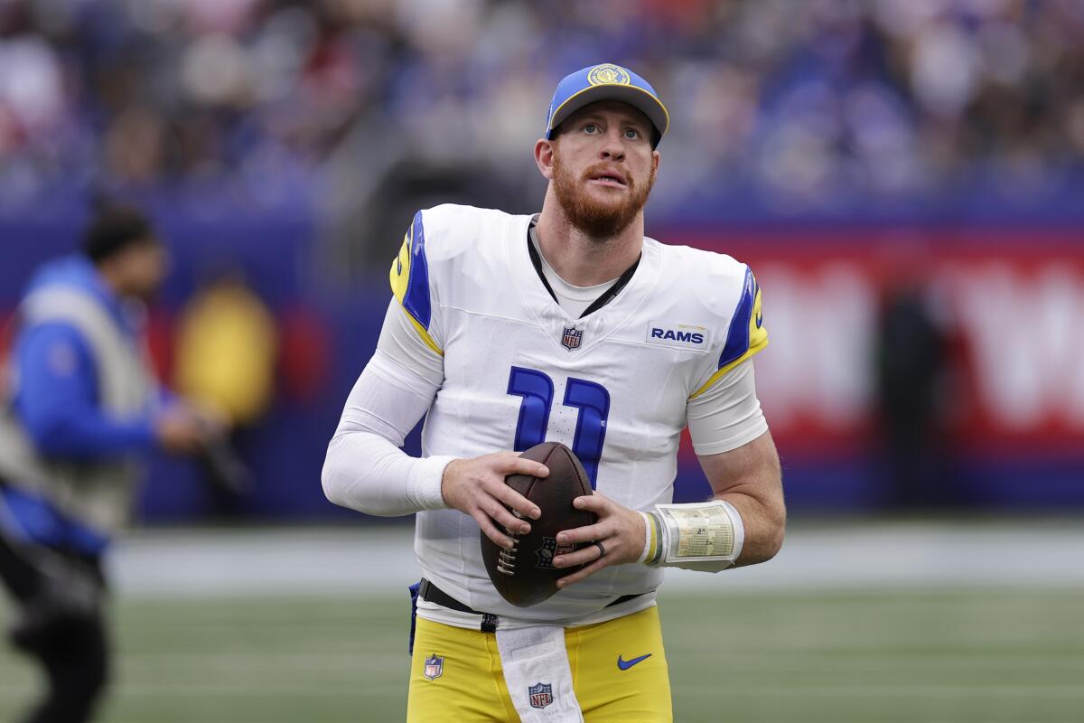 Rams quarterback Carson Wentz (11) warms up before a game against the New York Giants.