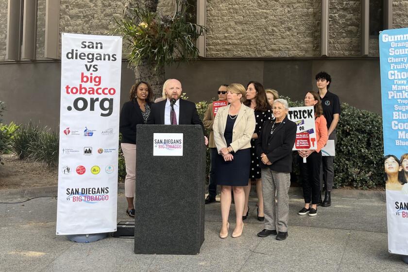 Andrian Kwiatkowski of the the San Diegans vs. Big Tobacco coalition speaks Tuesday during a news conference at Civic Center Plaza.