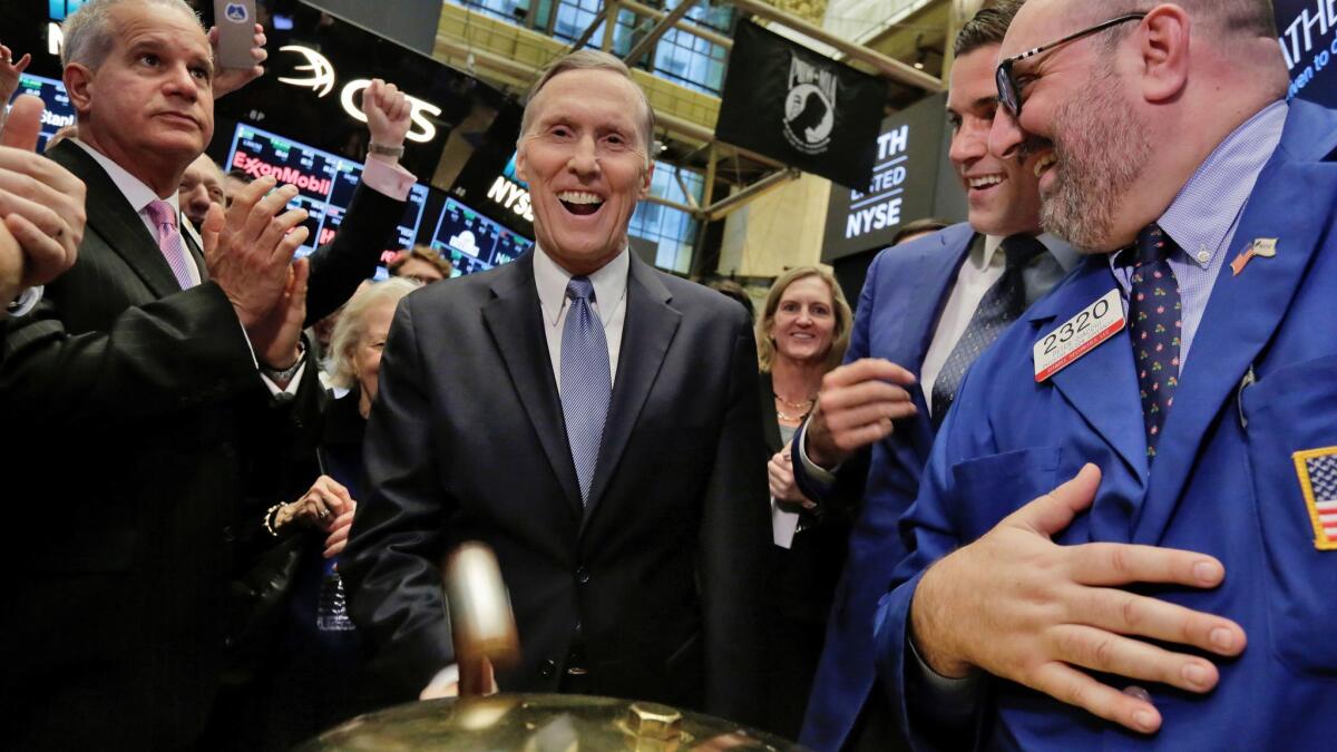Athene Holding Ltd. Chairman and CEO Jim Belardi, center, is applauded at the beginning of trades in his company's IPO, on the floor of the New York Stock Exchange on Dec. 9, 2016.