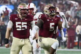 Jared Verse #5 of the Florida State Seminoles reacts with Braden Fiske #55.