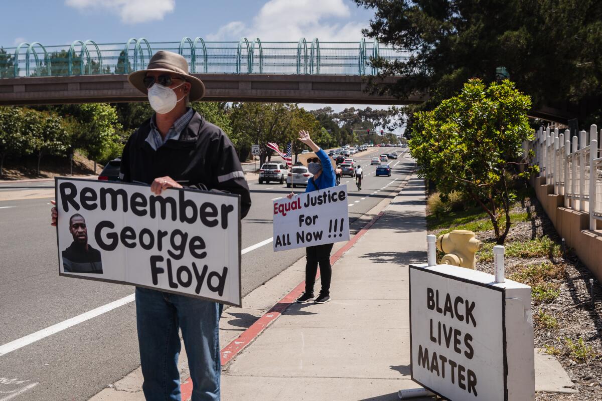 Gil Field, left, and Sheila Burke attend a racial justice rally held by the Carmel Valley for Equal Justice group