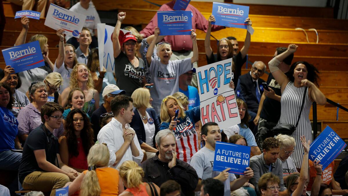 Supporters cheer before Democratic presidential candidate Hillary Clinton appears at an event with Sen. Bernie Sanders at Portsmouth High School in Portsmouth, N.H., on July 11.