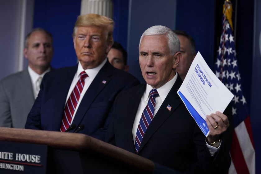 President Donald Trump listens as Vice President Mike Pence speaks during a coronavirus task force briefing at the White House, Friday, March 20, 2020, in Washington. (AP Photo/Evan Vucci)