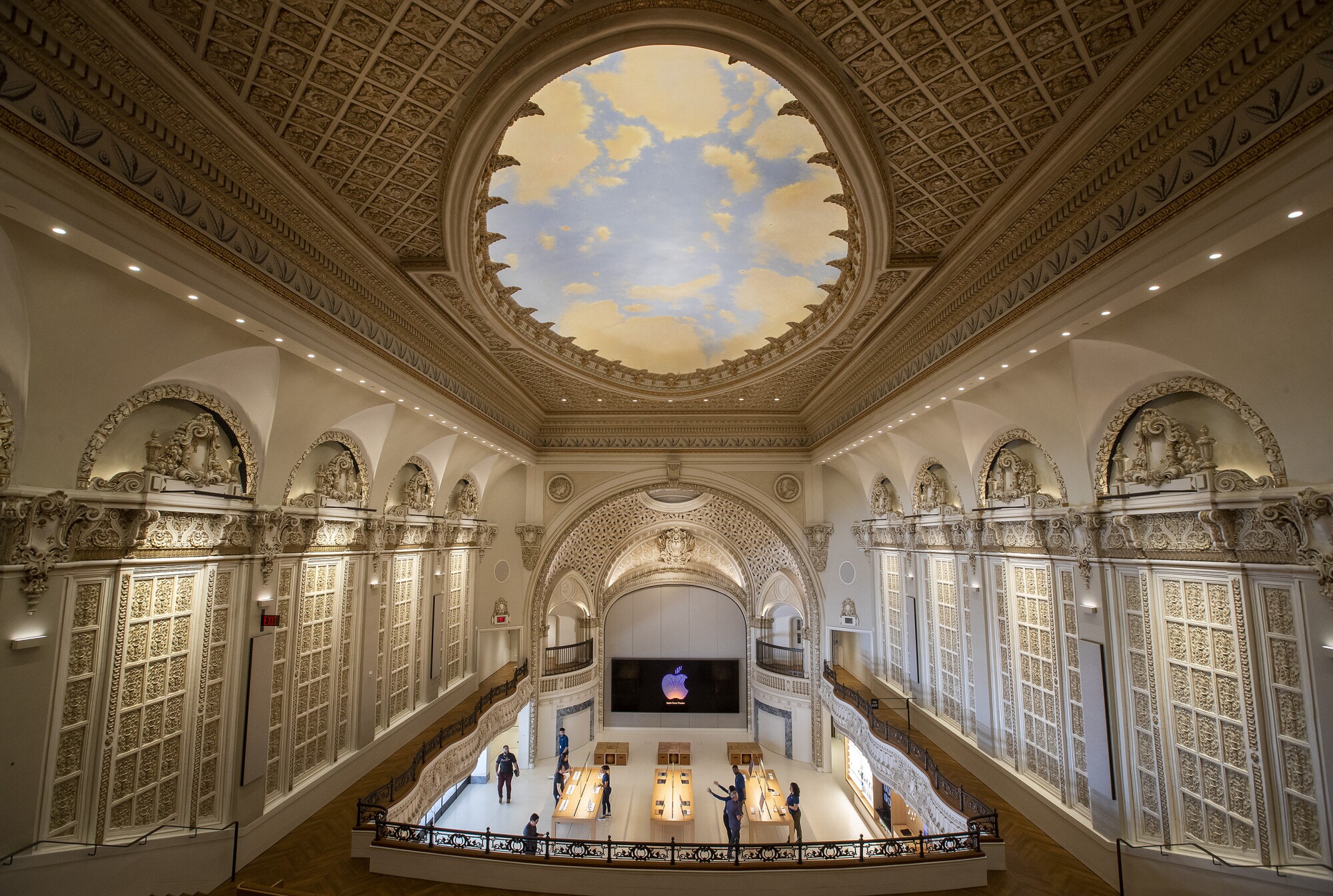 A view from the balcony of the Apple store in the Tower Theatre shows the room's decorative panels and painted ceiling