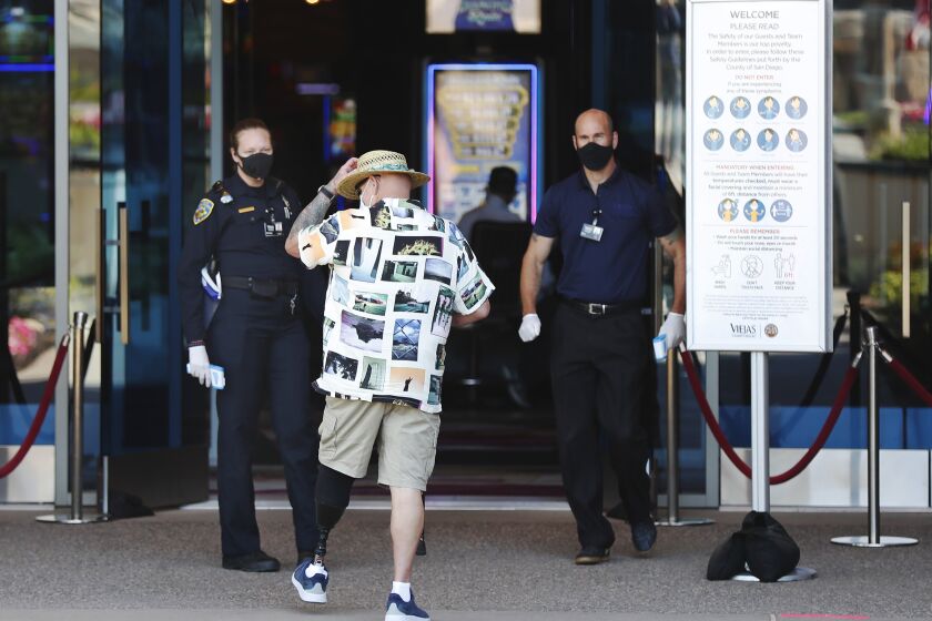 Hugh Henson gets his temperature checked as he heads into Viejas Casino & Resort after it reopened its doors to the public despite concerns from San Diego County and state health officials on May 18, 2020.