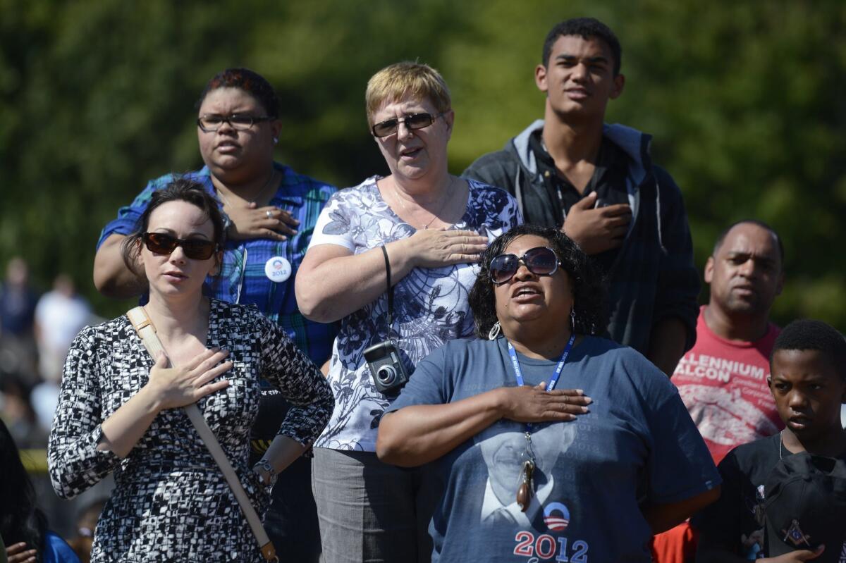 President Obama supporters say the Pledge of Allegiance prior to at a campaign rally in Woodbridge, Va.
