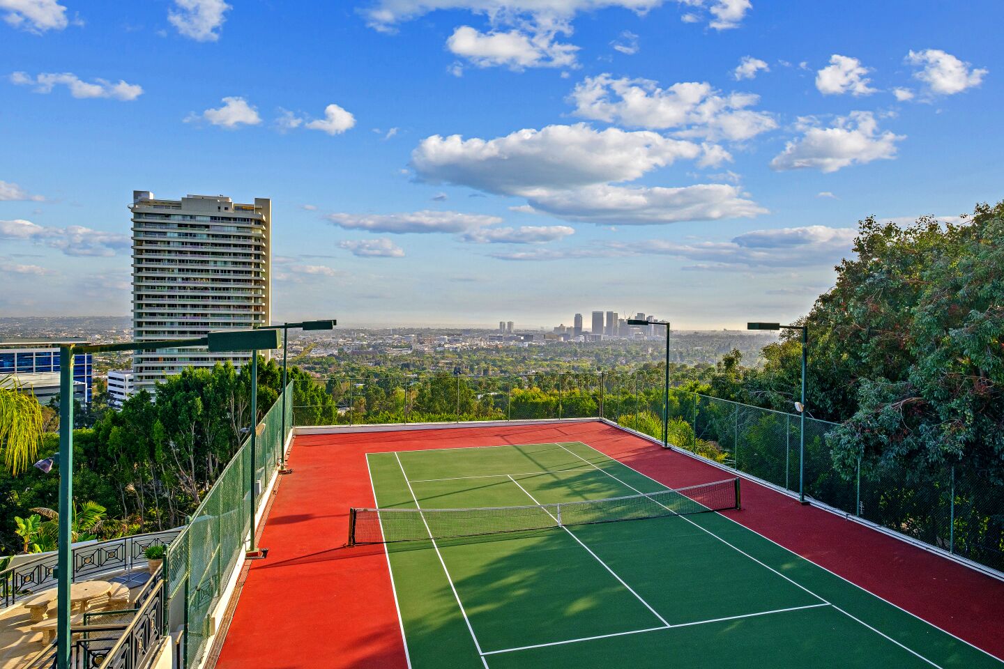 The estate includes a tennis court with a sweeping view from above the Sunset Strip.