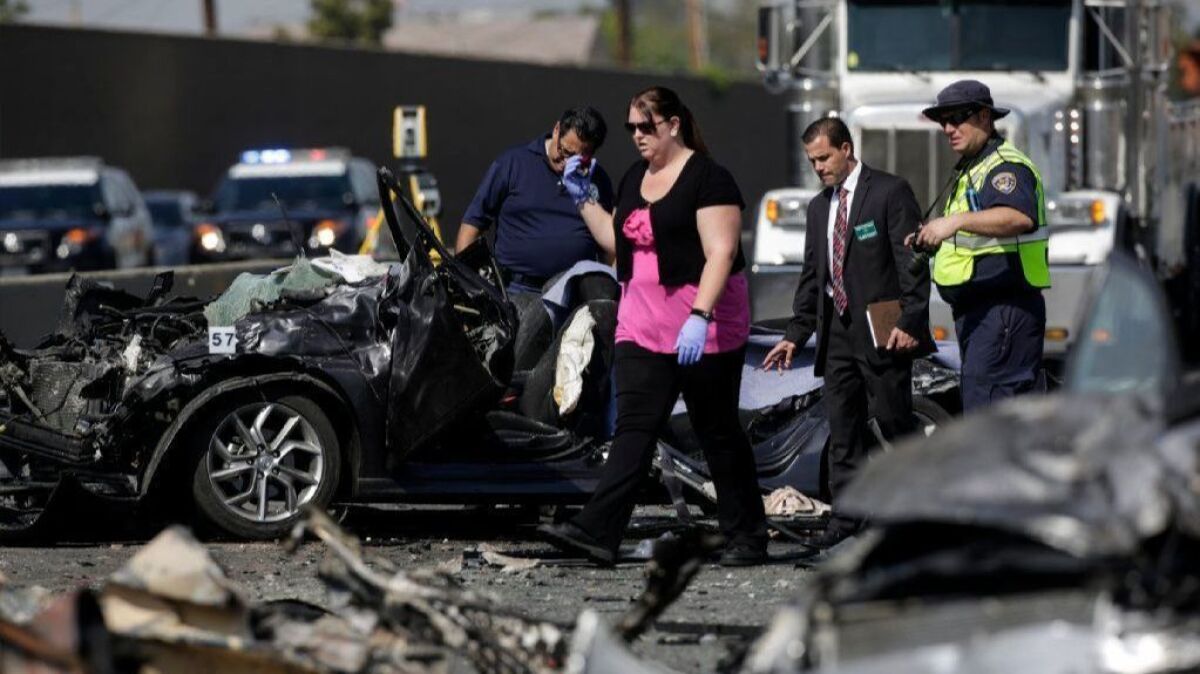 Authorities investigate a fiery crash on the 5 Freeway in Commerce that left three people dead.