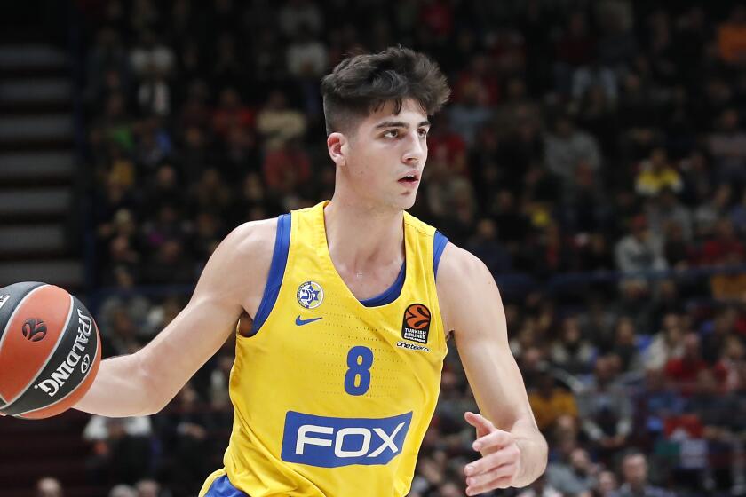 Deni Avdija brings the ball up court for Maccabi Fox Tel Aviv in a Euroleague game against Olimpia Milan on Nov. 19, 2019.