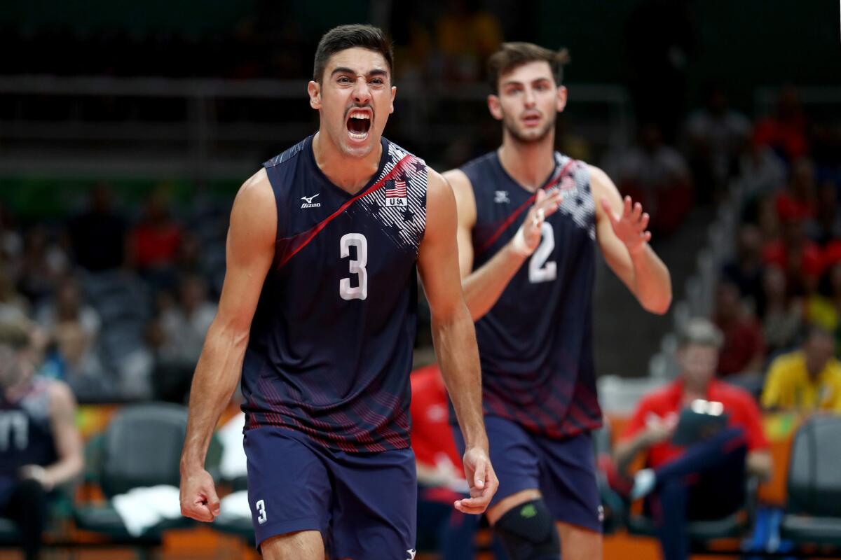 U.S. volleyball players Taylor Sander (3) and Aaron Russell react after scoring against Poland during their quarterfinal match.