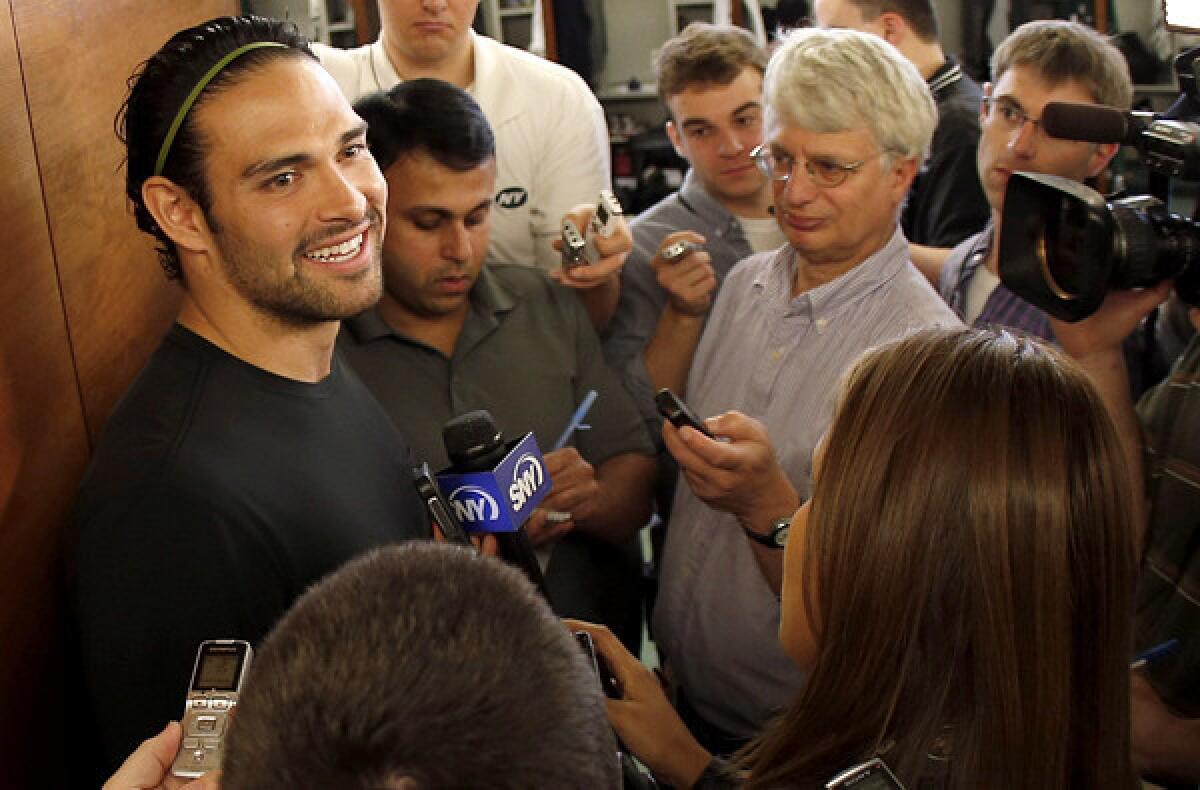 Jets quarterback Mark Sanchez talks to reporters on Thursday at the team's practice facility in Florham Park, N.J.