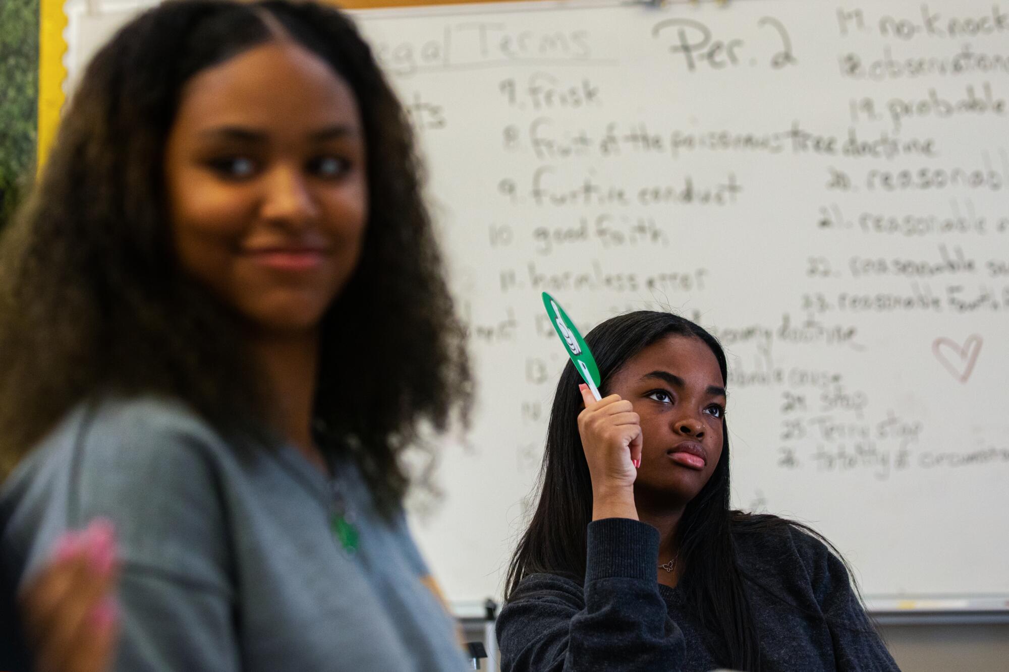 Two students listen attentively in their African American Studies class.