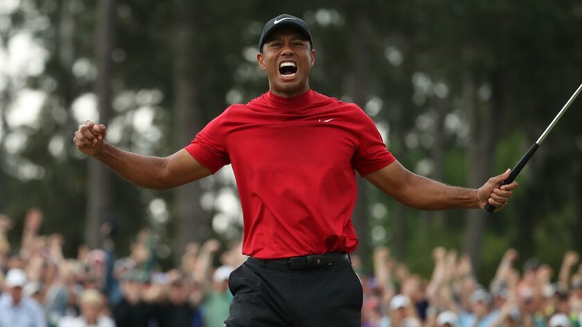 Tiger Woods celebrates after winning the Masters on Sunday. It was his first major championship since 2008 and his 15th such title overall.