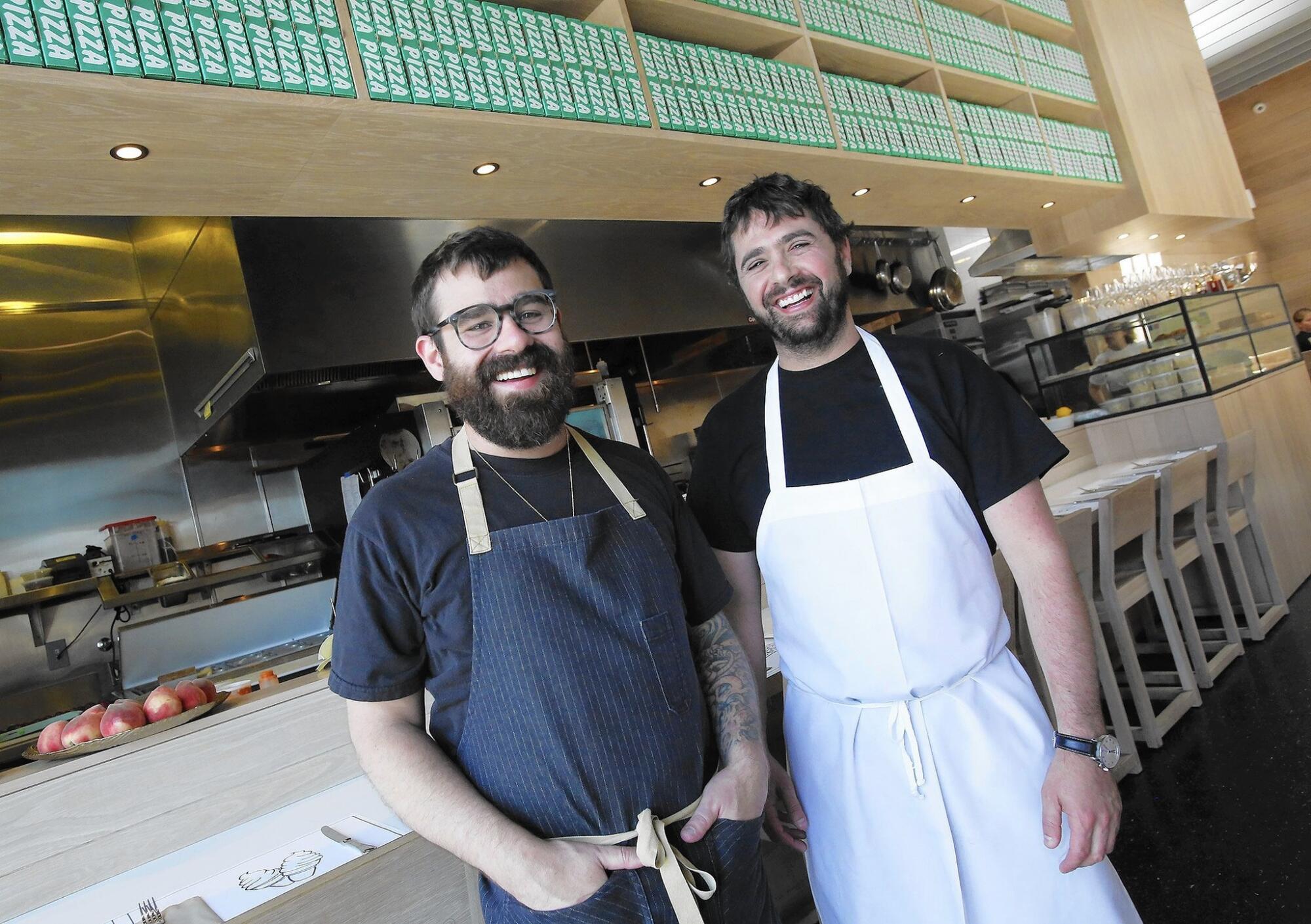 Two men in chef's aprons