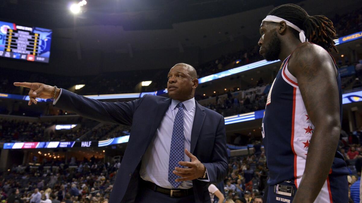 Doc Rivers talks with Clippers forward Montrezl Harrell during a game against Memphis on Feb. 22.