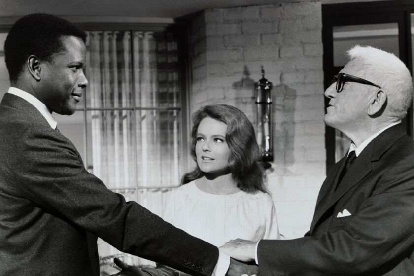 Actors Sidney Poitier, Katharine Houghton, and Spencer Tracy in a scene from the 1967 film, Guess Who's Coming to Dinner?, directed by Stanley Kramer. (Photo by George Rinhart/Corbis via Getty Images)