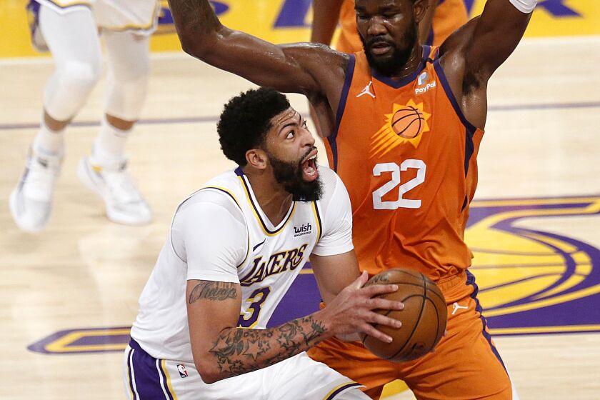 LOS ANGELES, CA - MAY 30: Los Angeles Lakers forward Anthony Davis (3) is guarded by Phoenix Suns center Deandre Ayton.