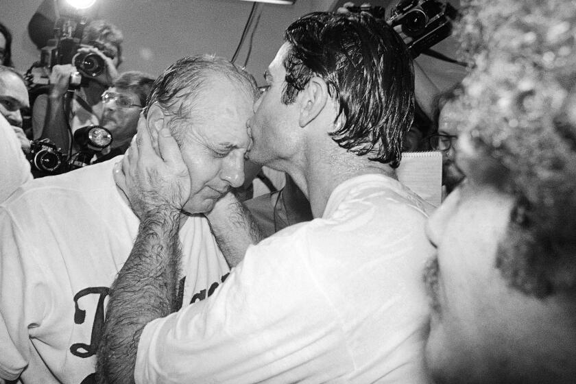 FILE - Los Angeles Dodgers' Steve Garvey kisses Dodger manager Tommy Lasorda,