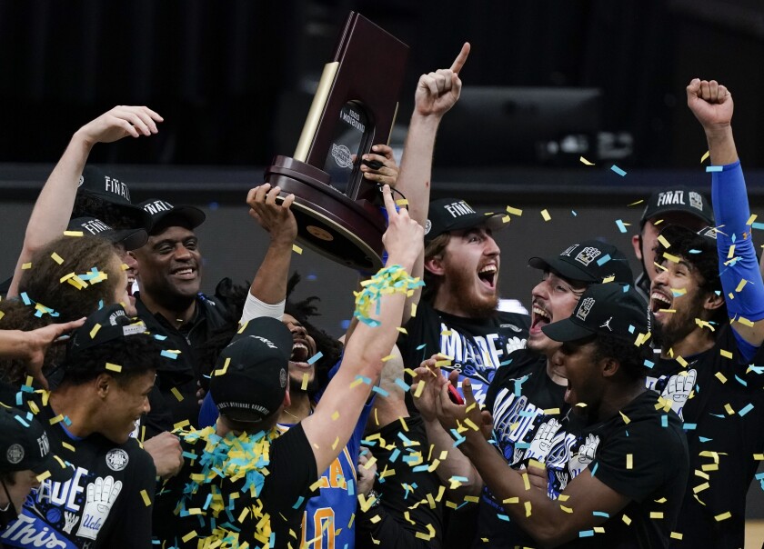 UCLA players celebrate after beating Michigan in the East Regional final Tuesday in Indianapolis.