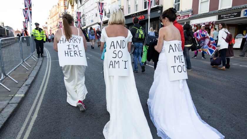 Alternate brides advertise their availability on the streets of Windsor, England, ahead of the royal wedding on May 19, 2018.