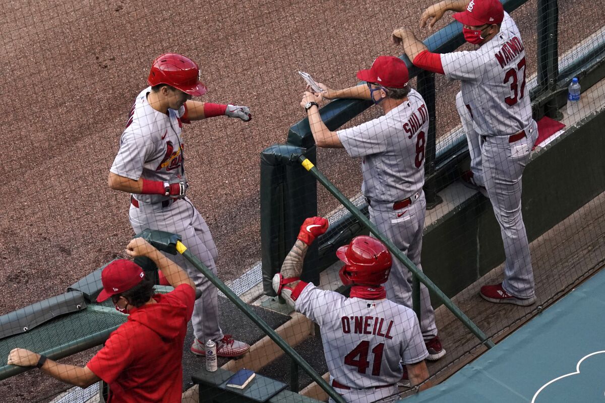 St. Louis Cardinals' Tommy Edman, left, celebrates with coaching staff members and a teammate after hitting a solo home run against the Chicago Cubs during the first inning of a baseball game in Chicago, Sunday, Sept. 6, 2020. (AP Photo/Nam Y. Huh)