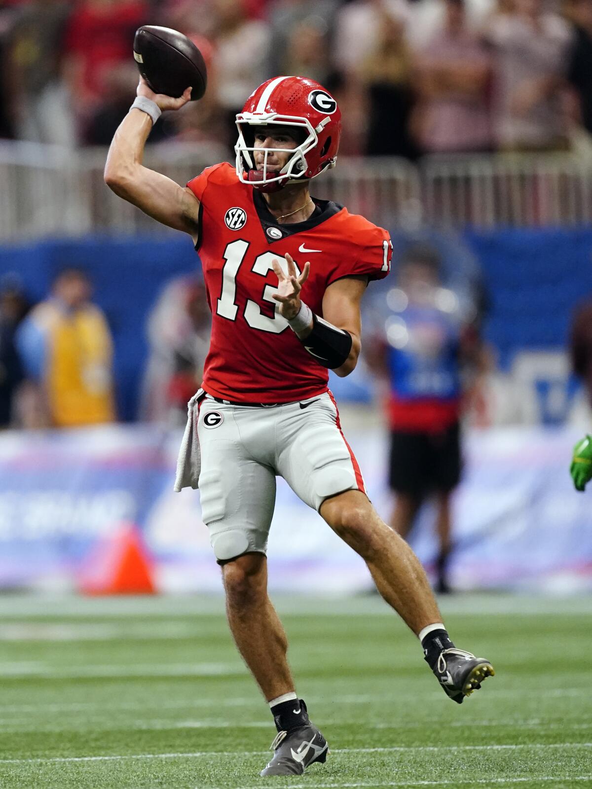 Georgia quarterback Stetson Bennett (13) throws on the run in the first half of an NCAA college football game against Oregon Saturday, Sept. 3, 2022, in Atlanta. (AP Photo/John Bazemore)