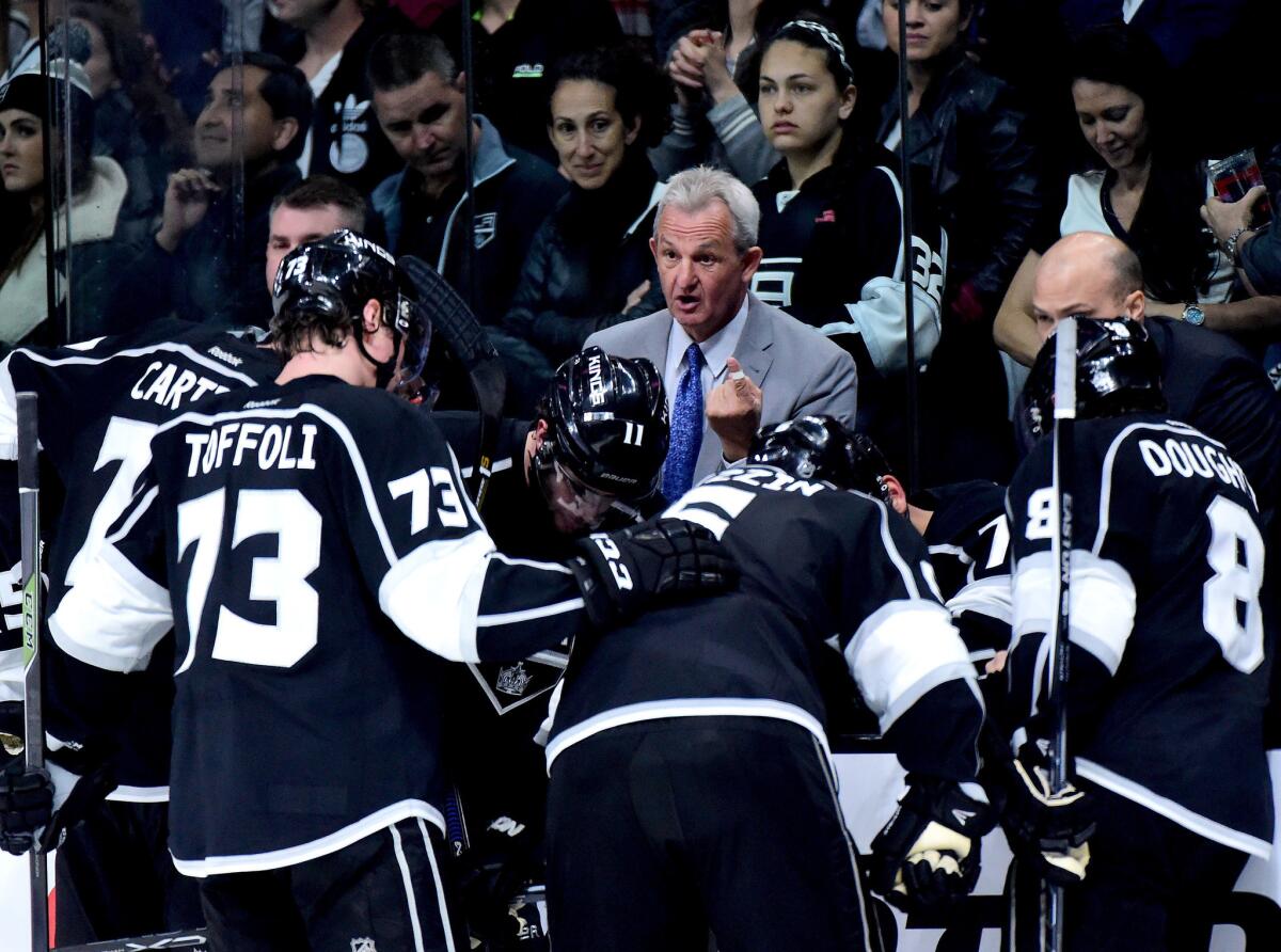 Kings Coach Darryl Sutter speaks to his players during a timeout in the third period of a 4-3 loss to the Sharks in Game 1 of their first-round playoff series.